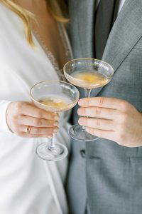couple holding bowl champagne glasses