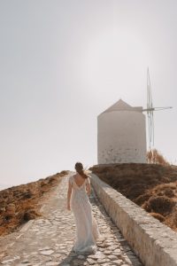 bride walking towards a windmill