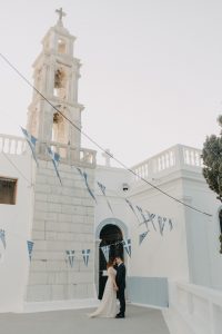 couple outside a big white church in Greece