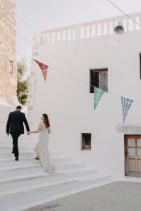 couple ascending stairs in small Astypalaia village