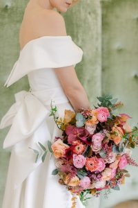 bride holding a fuchsia bouquet