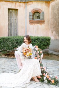 spring bride with her bouquet on a floral chair