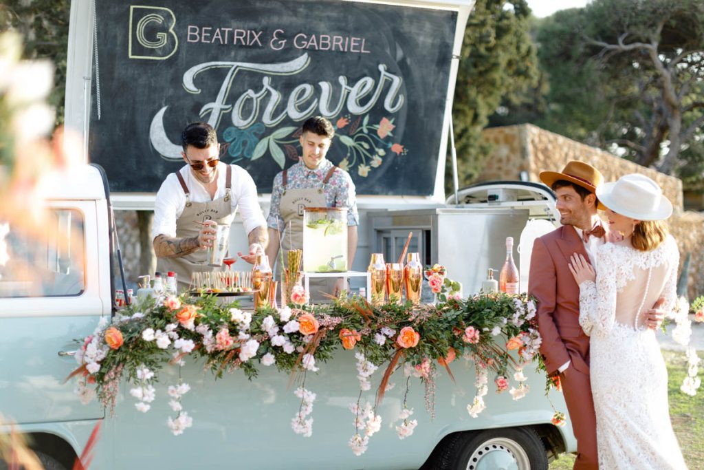 couple in front of a mobile bar van